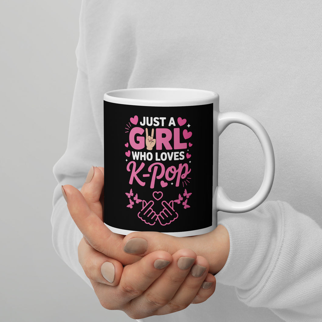 Mug with 'Just a Girl Who Loves K-Pop' text held by a person against a gray background